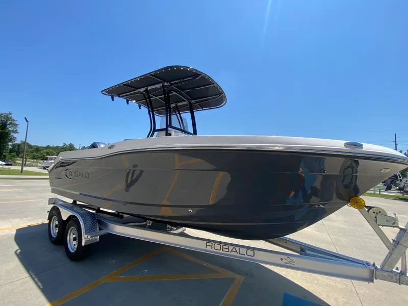 Slide: The Image of 2026 Robalo R200 Center Console boat on trailer under clear blue sky. - 2