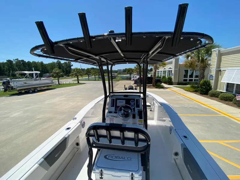 Slide: The Image of 2026 Robalo R200 Center Console boat with T-top, parked outdoors. - 5