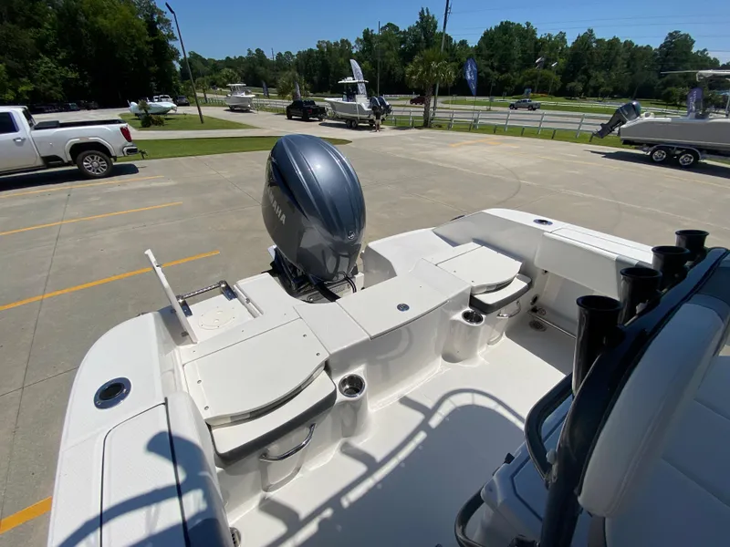 Slide: The Image of 2026 Robalo R200 Center Console boat with Yamaha outboard motor in a parking lot. - 6