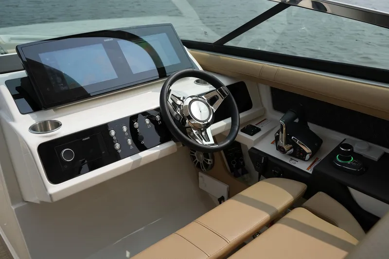 Slide: The Image of 2023 Sea Ray SLX 310 helm with modern controls and sleek design. - 11