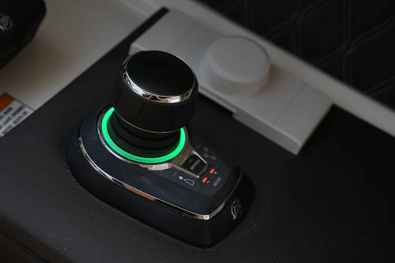 Slide: The Image of Joystick control on 2023 Sea Ray SLX 310 boat dashboard. - 15