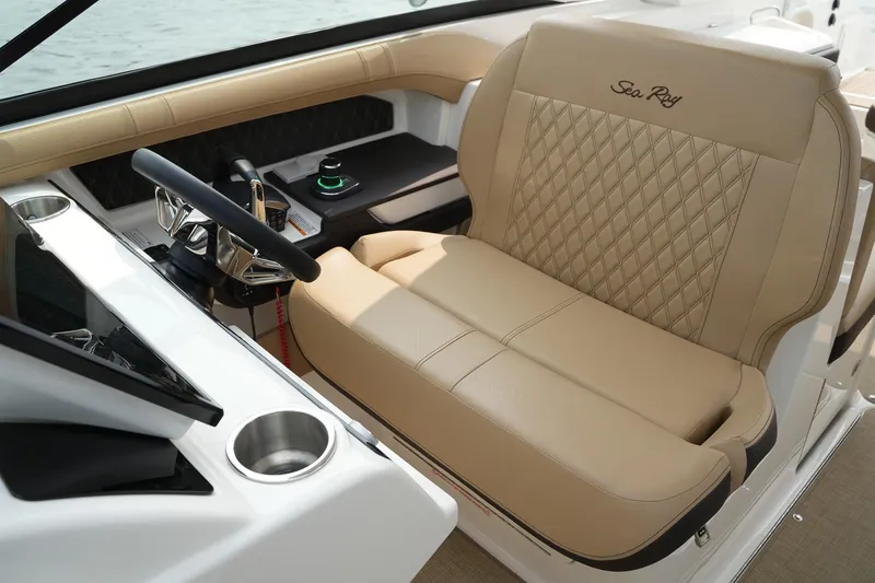 Slide: The Image of 2023 Sea Ray SLX 310 helm with luxurious tan seating and modern controls. - 20