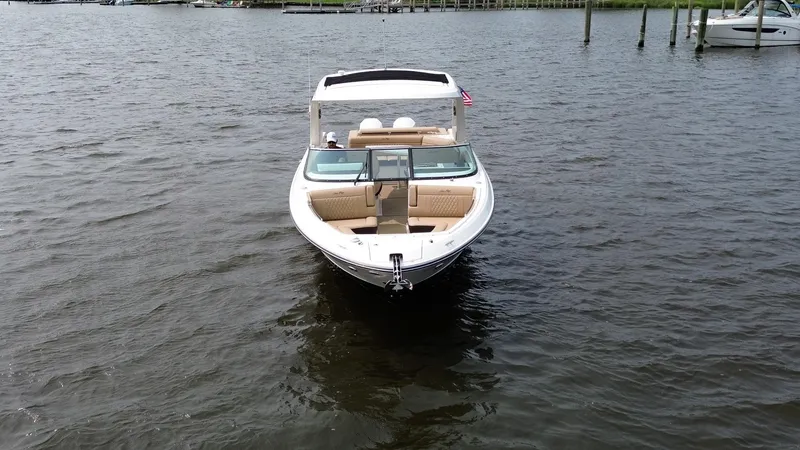 Slide: The Image of 2023 Sea Ray SLX 310 boat on calm water, front view. - 4