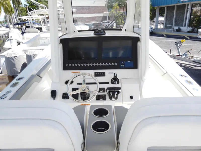 Slide: The Image of 2026 Regulator 28 boat cockpit with modern controls and dual cup holders. - 15