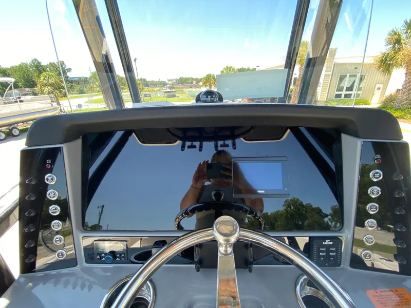 Slide: The Image of 2026 Robalo R230 Center Console dashboard with steering wheel and control panel. - 15