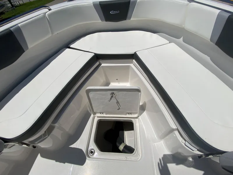 Slide: The Image of 2026 Robalo R230 Center Console boat interior with open storage compartment. - 21