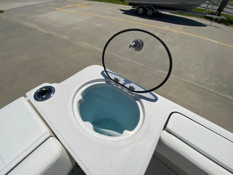 Slide: The Image of 2026 Robalo R230 Center Console boat with open livewell on deck. - 7