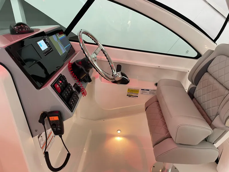 Slide: The Image of 2024 Pursuit DC 246 Dual Console helm with modern controls and comfortable seating. - 11