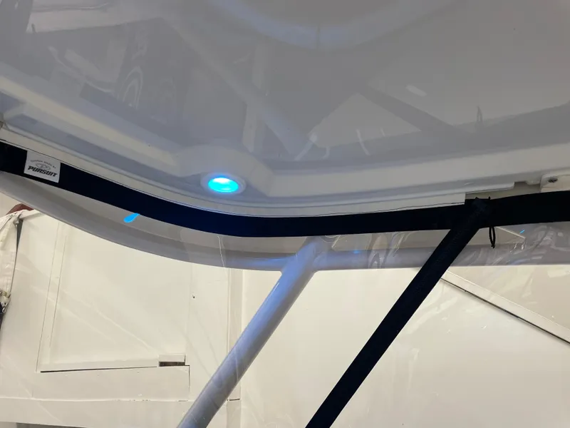 Slide: The Image of 2024 Pursuit DC 246 Dual Console interior with blue LED light. - 12