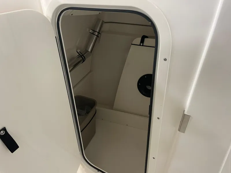 Slide: The Image of 2024 Pursuit DC 246 Dual Console interior storage compartment. - 14