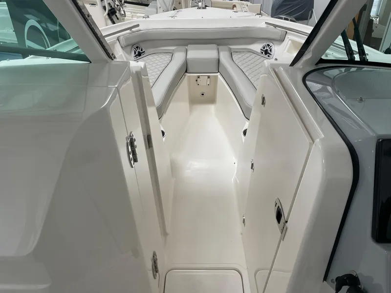 Slide: The Image of 2024 Pursuit DC 246 Dual Console boat interior with seating and storage. - 15