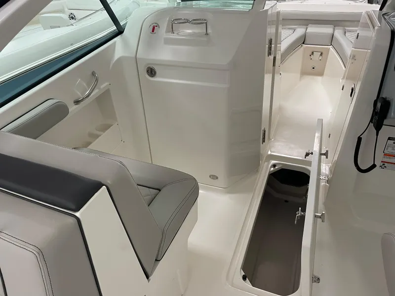 Slide: The Image of 2024 Pursuit DC 246 Dual Console interior with seating and storage compartments. - 17