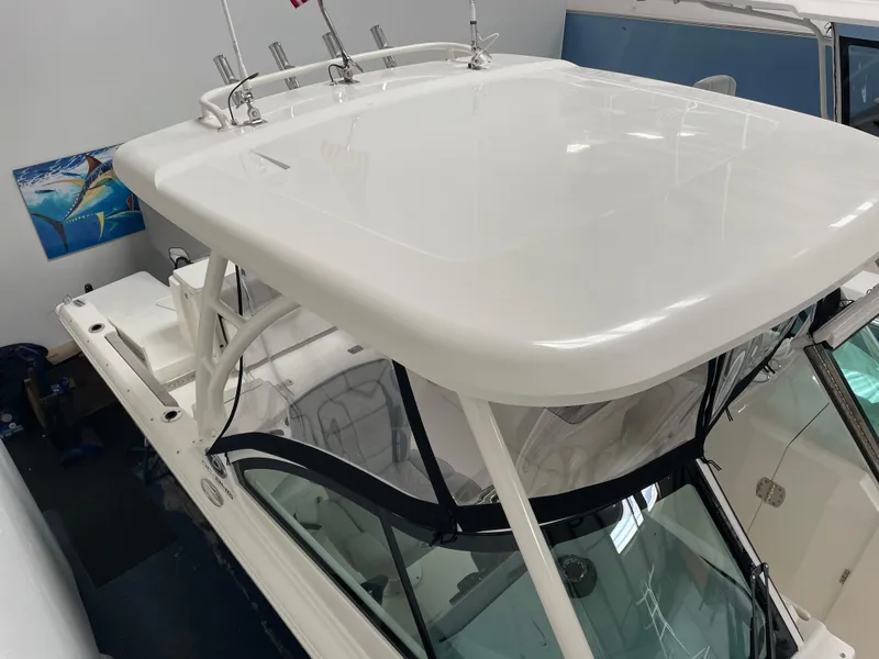 Slide: The Image of 2024 Pursuit DC 246 Dual Console boat with hardtop and rod holders. - 2