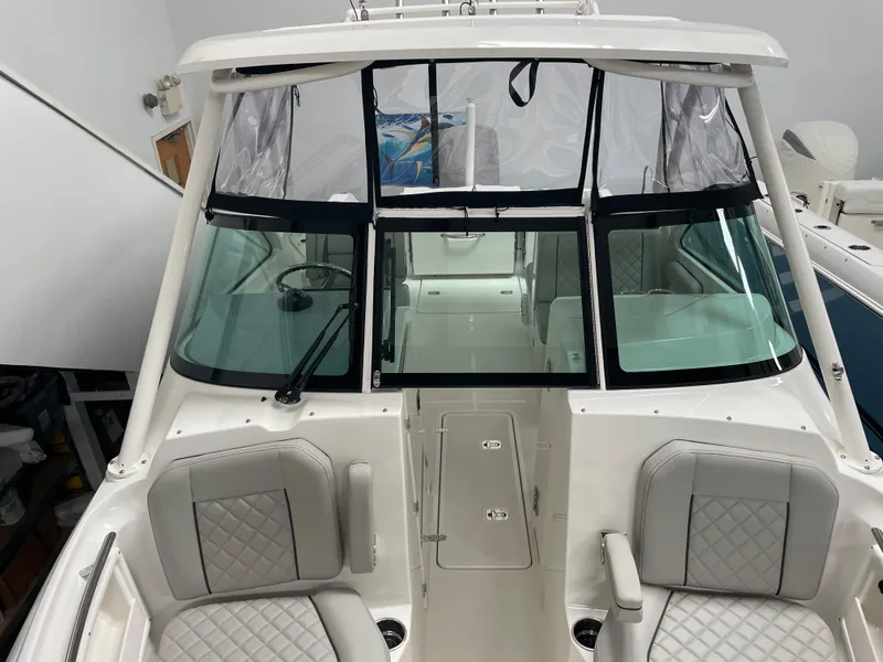 Slide: The Image of 2024 Pursuit DC 246 Dual Console boat interior with seating and windshield. - 22