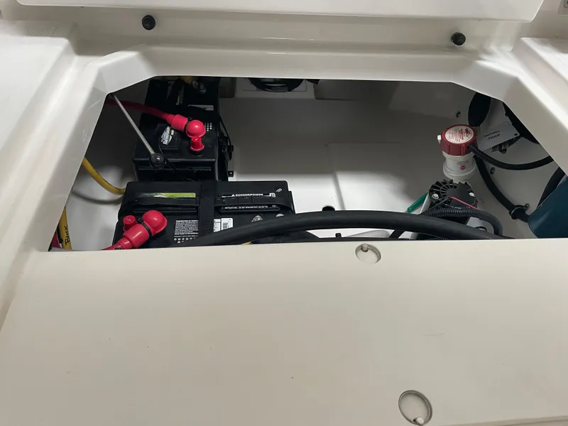 Slide: The Image of 2024 Pursuit DC 246 Dual Console battery compartment. - 25