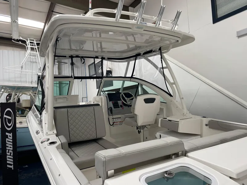 Slide: The Image of 2024 Pursuit DC 246 Dual Console boat interior with seating and helm station. - 3
