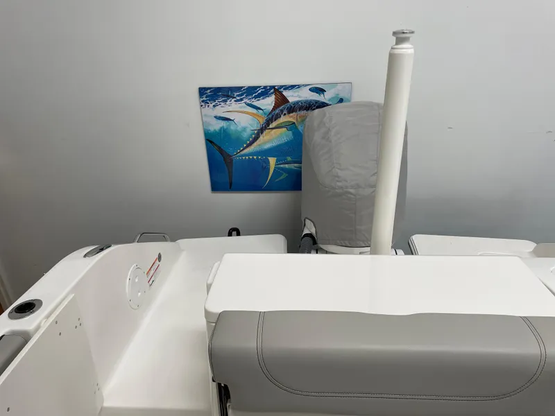 Slide: The Image of 2024 Pursuit DC 246 Dual Console boat interior with a marine-themed wall art. - 4