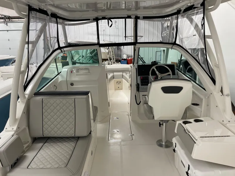 Slide: The Image of 2024 Pursuit DC 246 Dual Console interior, featuring helm, seating, and modern design. - 7