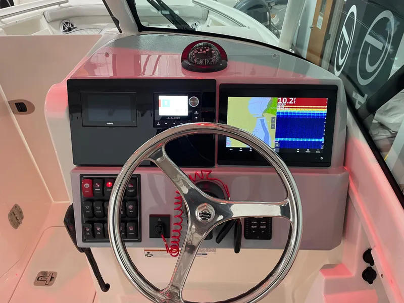 Slide: The Image of 2024 Pursuit DC 246 Dual Console helm with navigation screens and controls. - 9