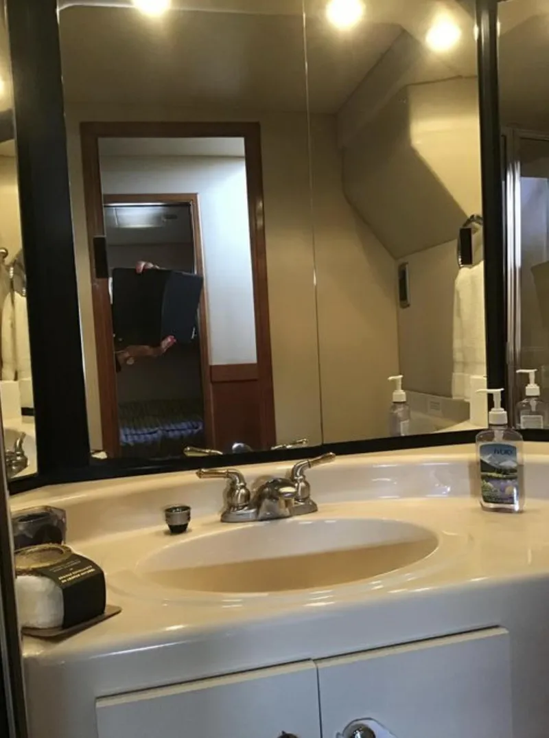 Slide: The Image of Bathroom vanity in a 2004 Meridian 490 Pilothouse yacht, featuring a sink and mirror. - 10