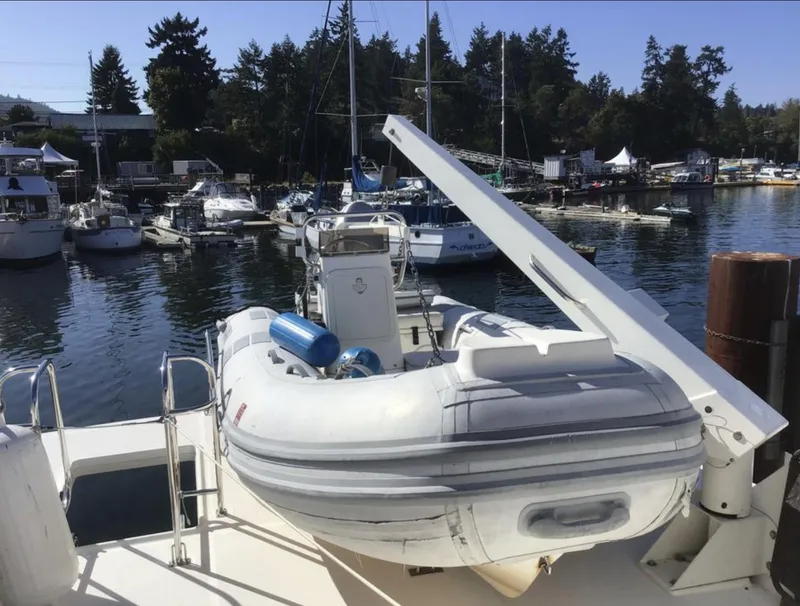 Slide: The Image of 2004 Meridian 490 Pilothouse with inflatable boat at marina. - 2