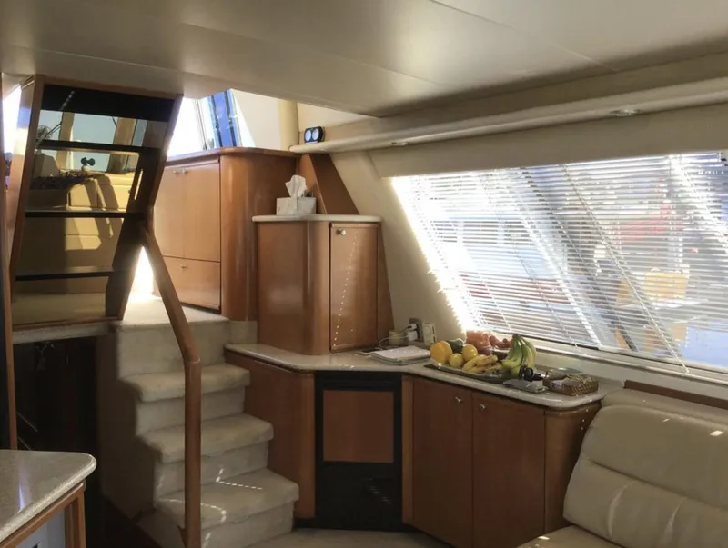 Slide: The Image of Luxurious interior of 2004 Meridian 490 Pilothouse yacht with modern kitchen and seating area. - 5
