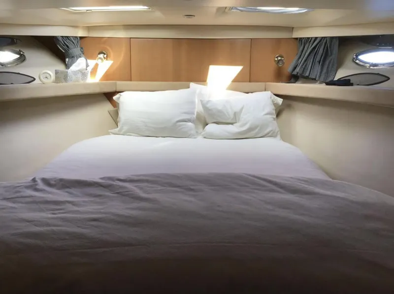 Slide: The Image of Cozy bedroom in 2004 Meridian 490 Pilothouse yacht with natural light and plush bedding. - 6