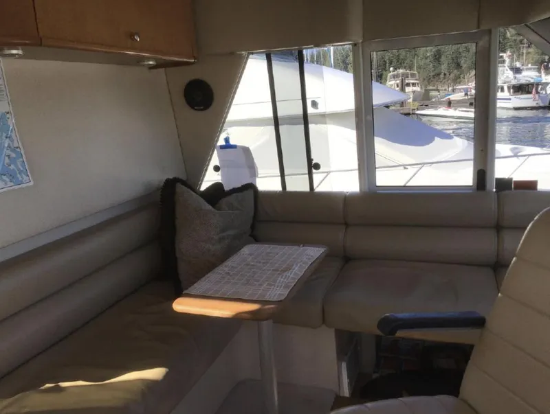 Slide: The Image of Interior of 2004 Meridian 490 Pilothouse yacht with seating and table by window. - 8