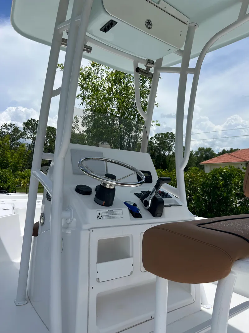 Slide: The Image of 2013 Sportsman 227 MASTERS boat console with steering wheel and controls. - 14