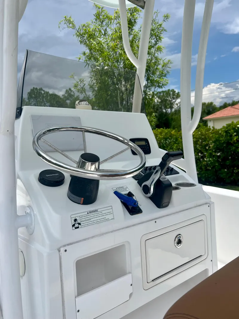 Slide: The Image of 2013 Sportsman 227 MASTERS boat console with steering wheel and controls. - 22