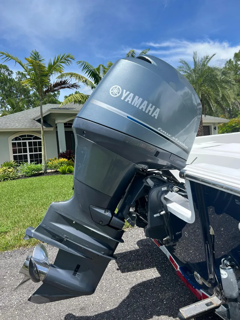 Slide: The Image of 2013 Sportsman 227 MASTERS with Yamaha outboard motor in a residential driveway. - 26