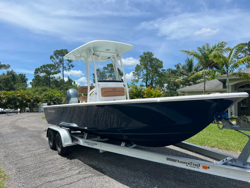 Slide: The Image of 2013 Sportsman 227 MASTERS boat on AmeraTrail trailer in a residential area. - 5