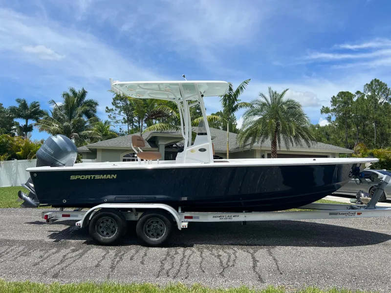 Slide: The Image of 2013 Sportsman 227 MASTERS boat on a trailer, parked in a residential area. - 8
