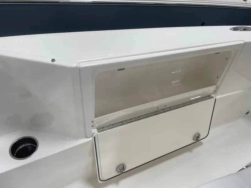 Slide: The Image of 2024 Pursuit S 248 Sport boat storage compartment with open hatch. - 10