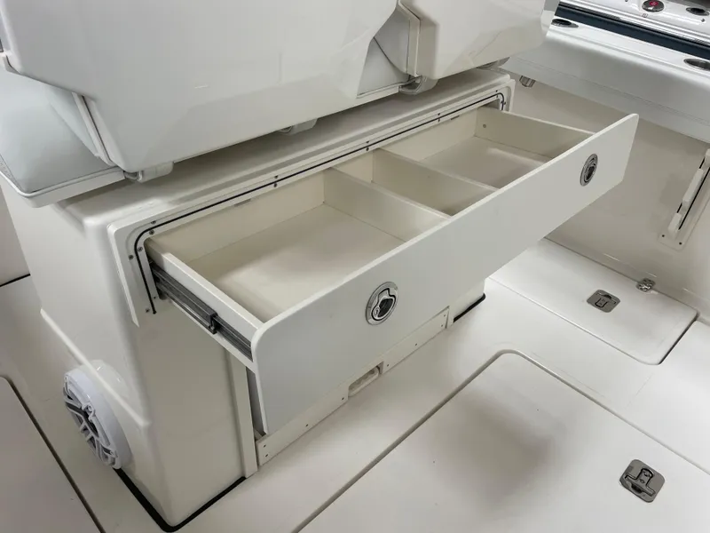 Slide: The Image of 2024 Pursuit S 248 Sport boat with open storage compartment. - 14