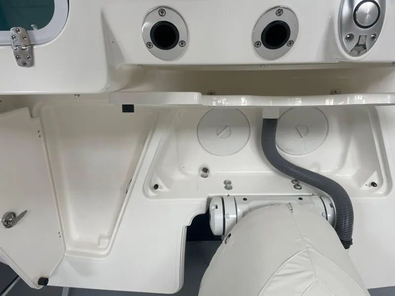 Slide: The Image of 2024 Pursuit S 248 Sport boat interior, showing storage compartments and utility features. - 18