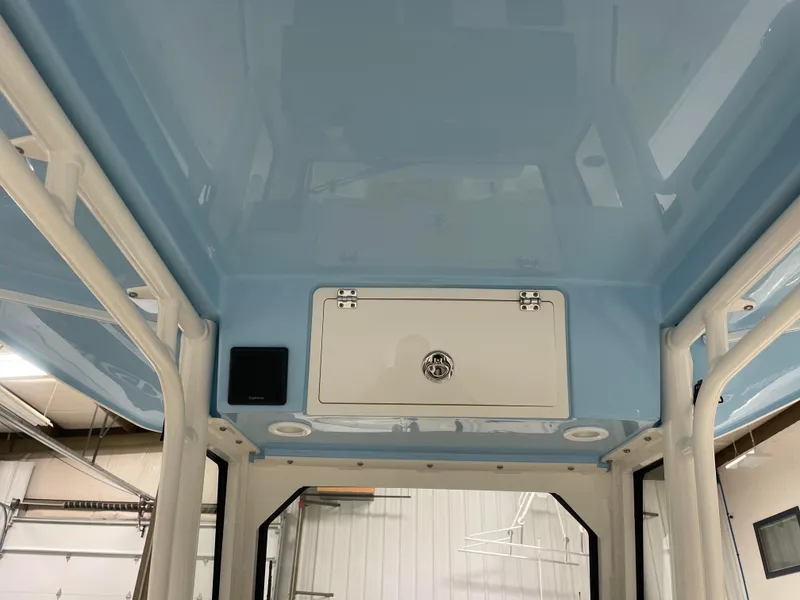 Slide: The Image of 2024 Pursuit S 248 Sport boat interior ceiling with storage compartment. - 7