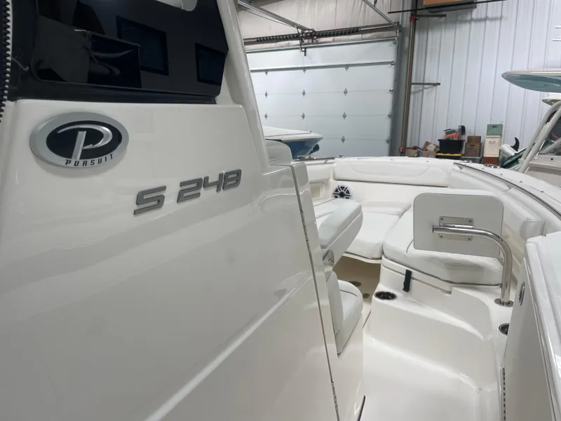 Slide: The Image of 2024 Pursuit S 248 Sport boat interior in a garage. - 8