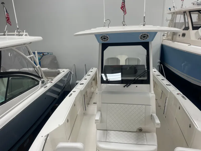 Slide: The Image of 2024 Pursuit S 248 Sport boat interior with center console and seating. - 9