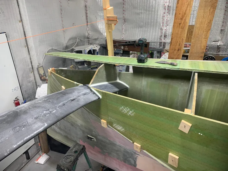 Slide: The Image of 2024 Schionning Arrow 1280 S under construction in a workshop. - 16