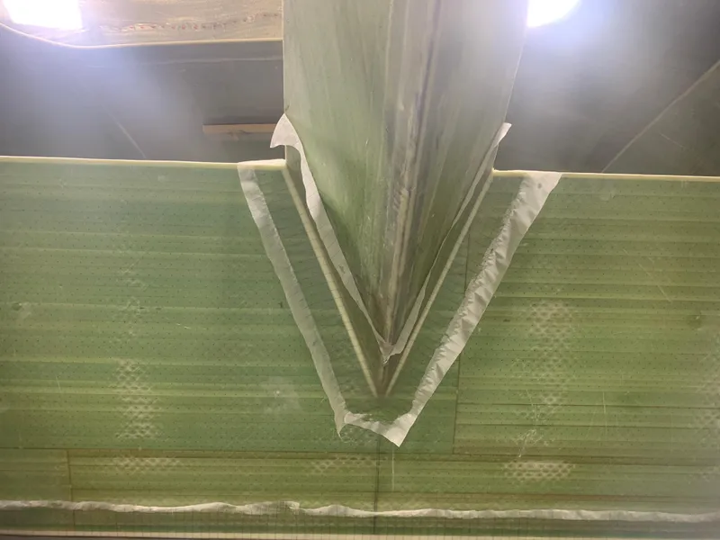 Slide: The Image of Close-up of Schionning Arrow 1280 S 2024 catamaran hull construction. - 19