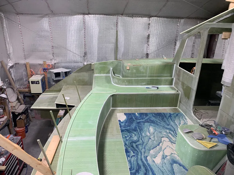 Slide: The Image of Construction of 2024 Schionning Arrow 1280 S catamaran in a workshop. - 25