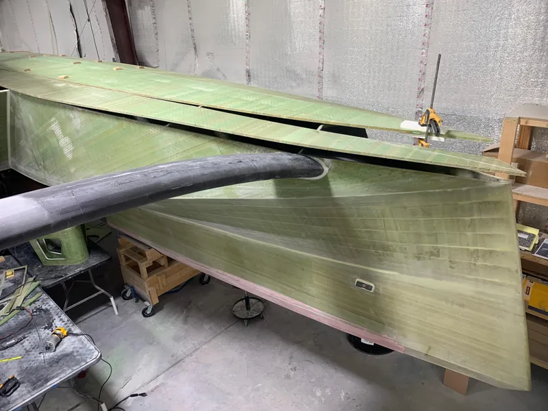 Slide: The Image of 2024 Schionning Arrow 1280 S catamaran under construction in a workshop. - 29