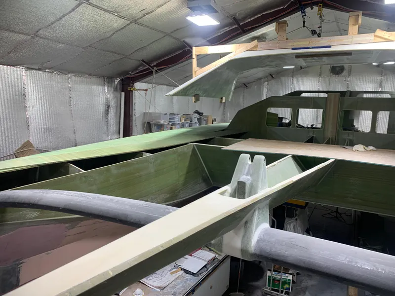 Slide: The Image of 2024 Schionning Arrow 1280 S catamaran under construction in a workshop. - 33