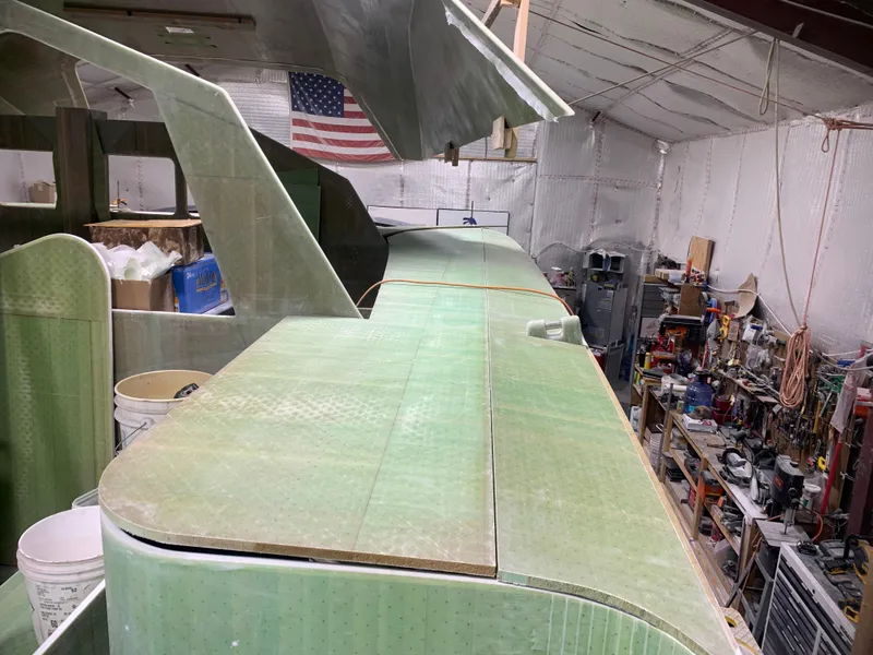 Slide: The Image of 2024 Schionning Arrow 1280 S catamaran under construction in a workshop. - 36