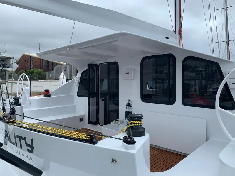 Slide: The Image of 2024 Schionning Arrow 1280 S catamaran with sleek design docked at marina. - 47