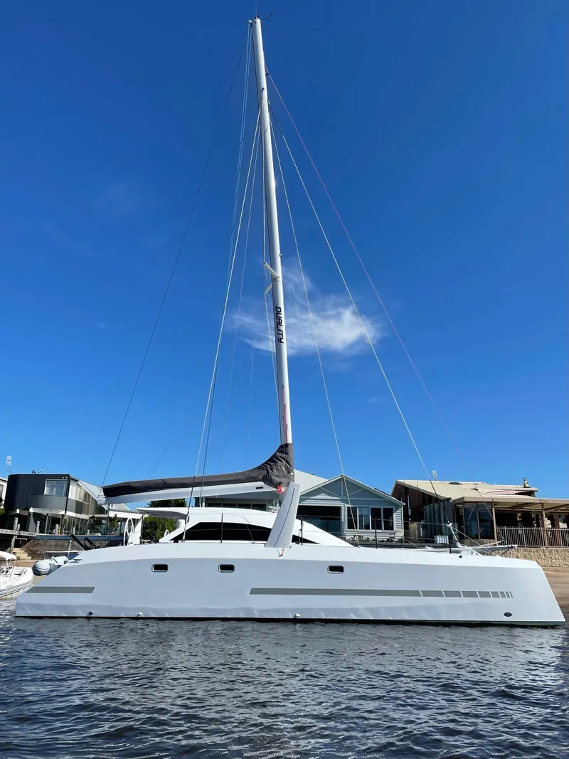 Slide: The Image of 2024 Schionning Arrow 1280 S catamaran sailing on the ocean. - 5