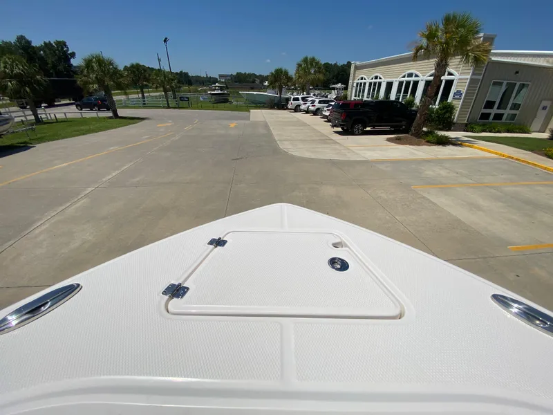 Slide: The Image of 2024 Robalo R230 Center Console boat bow view at a marina. - 27