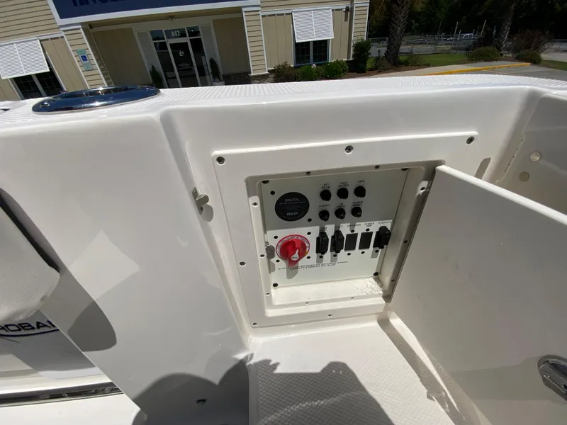 Slide: The Image of 2024 Robalo R230 Center Console control panel with open access door. - 12