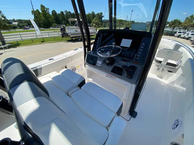 Slide: The Image of 2024 Robalo R230 Center Console boat interior with helm and seating. - 13